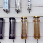 Short IK10-rated decorative tubular lights with metal mesh, honeycomb, and patterned cores – gold, black, pink, and silver architectural tube fixtures for interior lighting