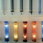 Decorative short LED tube lights with patterned metal mesh and colored end caps – E27-style tubular fixtures in warm and cool lighting for interior architectural applications