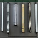 Decorative industrial LED tubular lights with metal mesh covers in gold, black, and silver – architectural tube lights for commercial interior lighting display