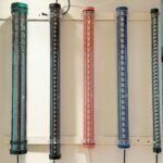 Colored LED tubular lights with louver-style internal reflectors – decorative industrial tube lighting for architectural and commercial interiors