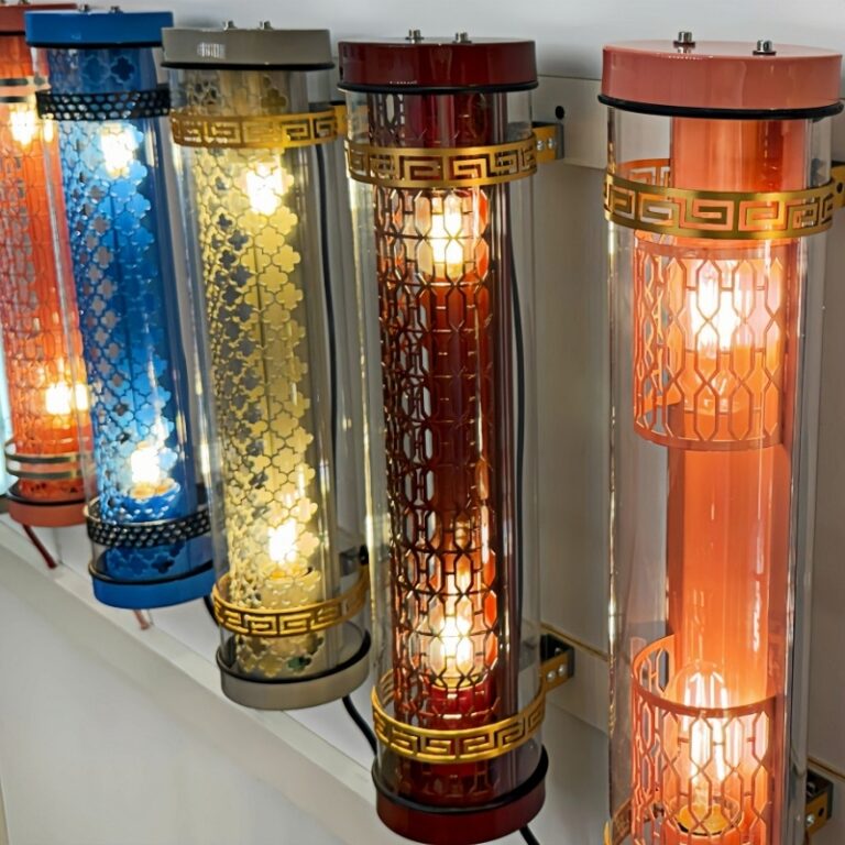 Decorative tubular wall lights with metal grille inserts, E27 lamp design, available in multiple colours and ornamental patterns for architectural lighting applications