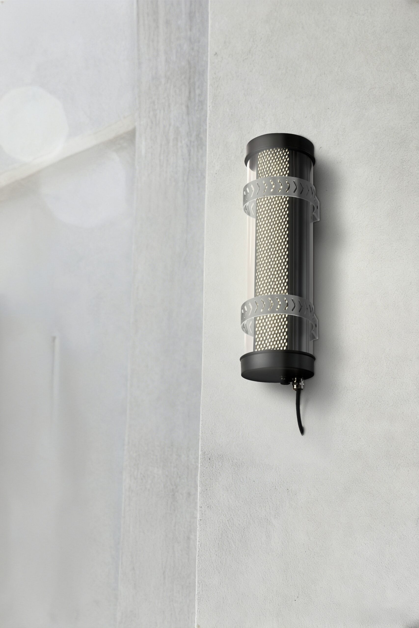 Arno IP67 IK10 architectural tubular wall lights installed on an outdoor building façade for long-term weather-resistant lighting