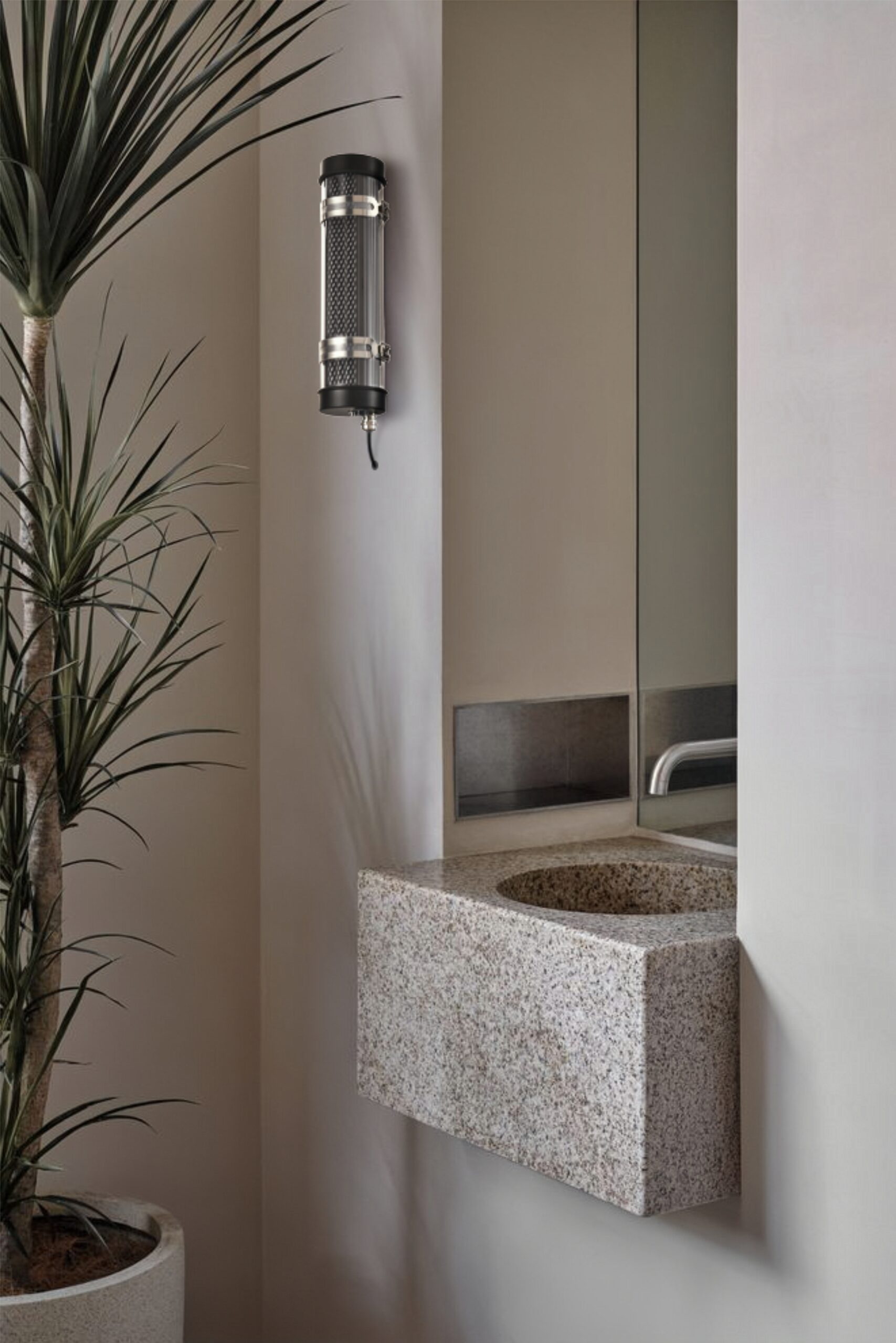 Arno IP67 IK10 architectural tubular wall lights installed on an outdoor building façade for long-term weather-resistant lighting