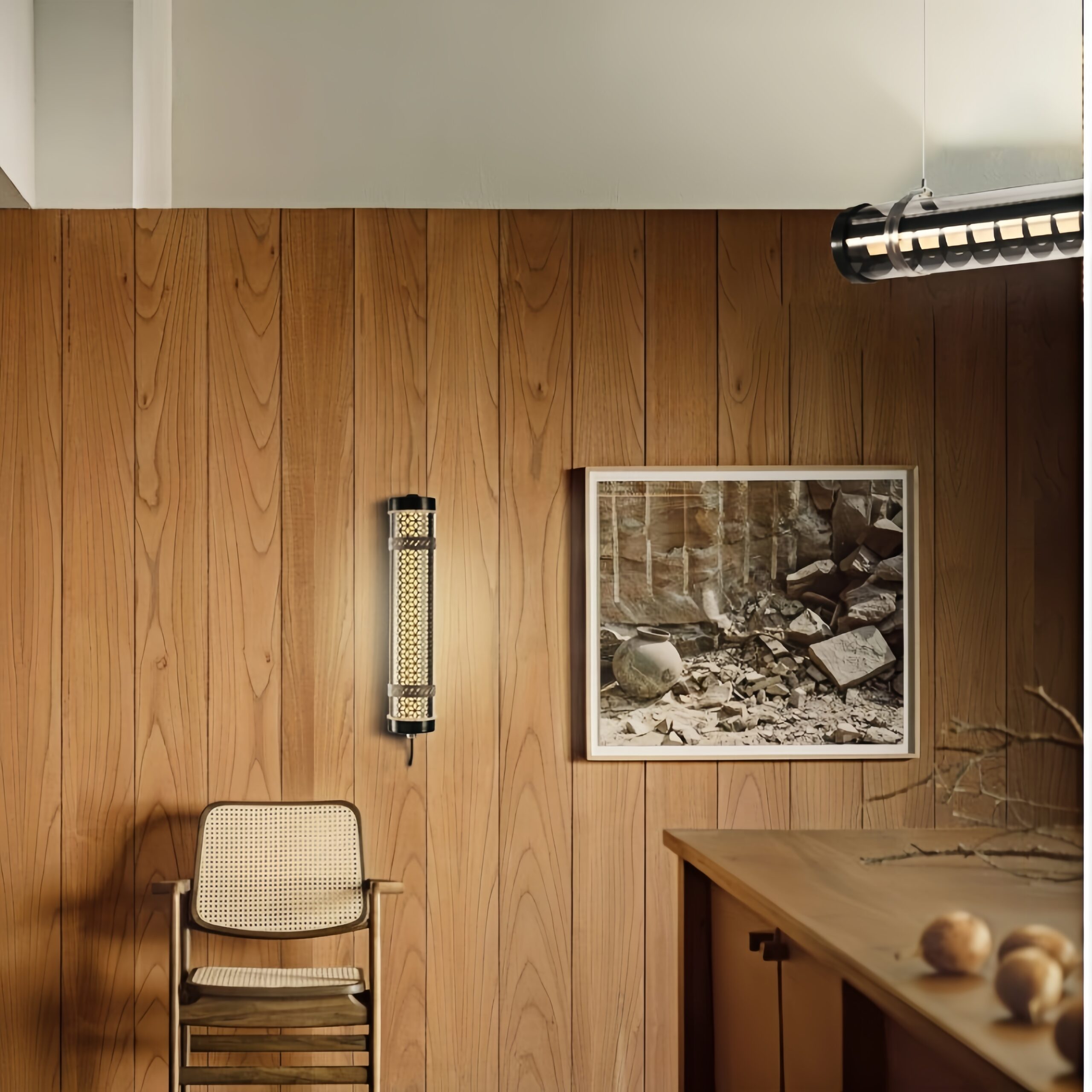 Architectural tubular wall luminaire integrated into interior space with warm ambient lighting