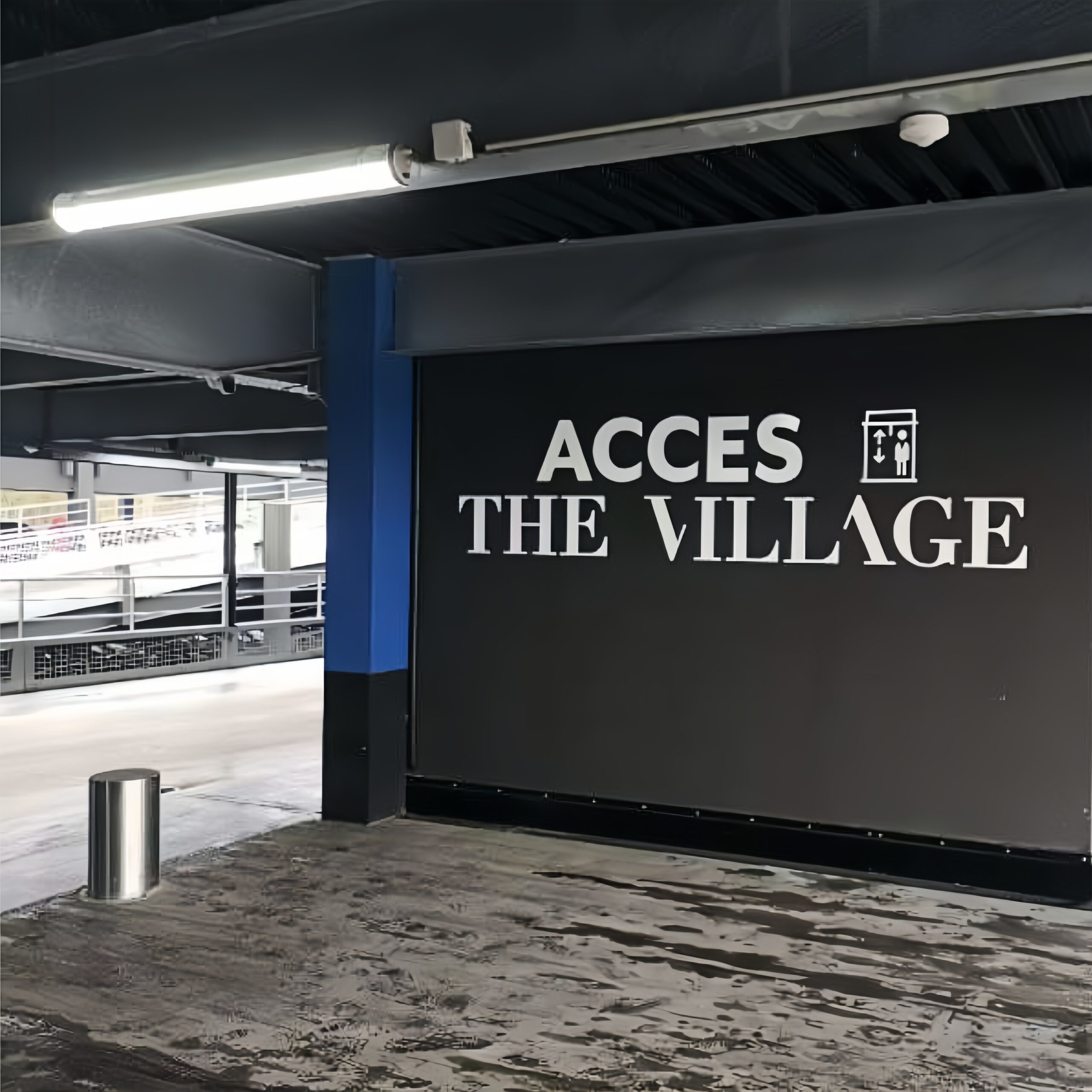 MANI Tri-Proof Tubular LED light installed in a parking garage in France Lyon The Village — industrial waterproof LED tube lighting for commercial and architectural projects.