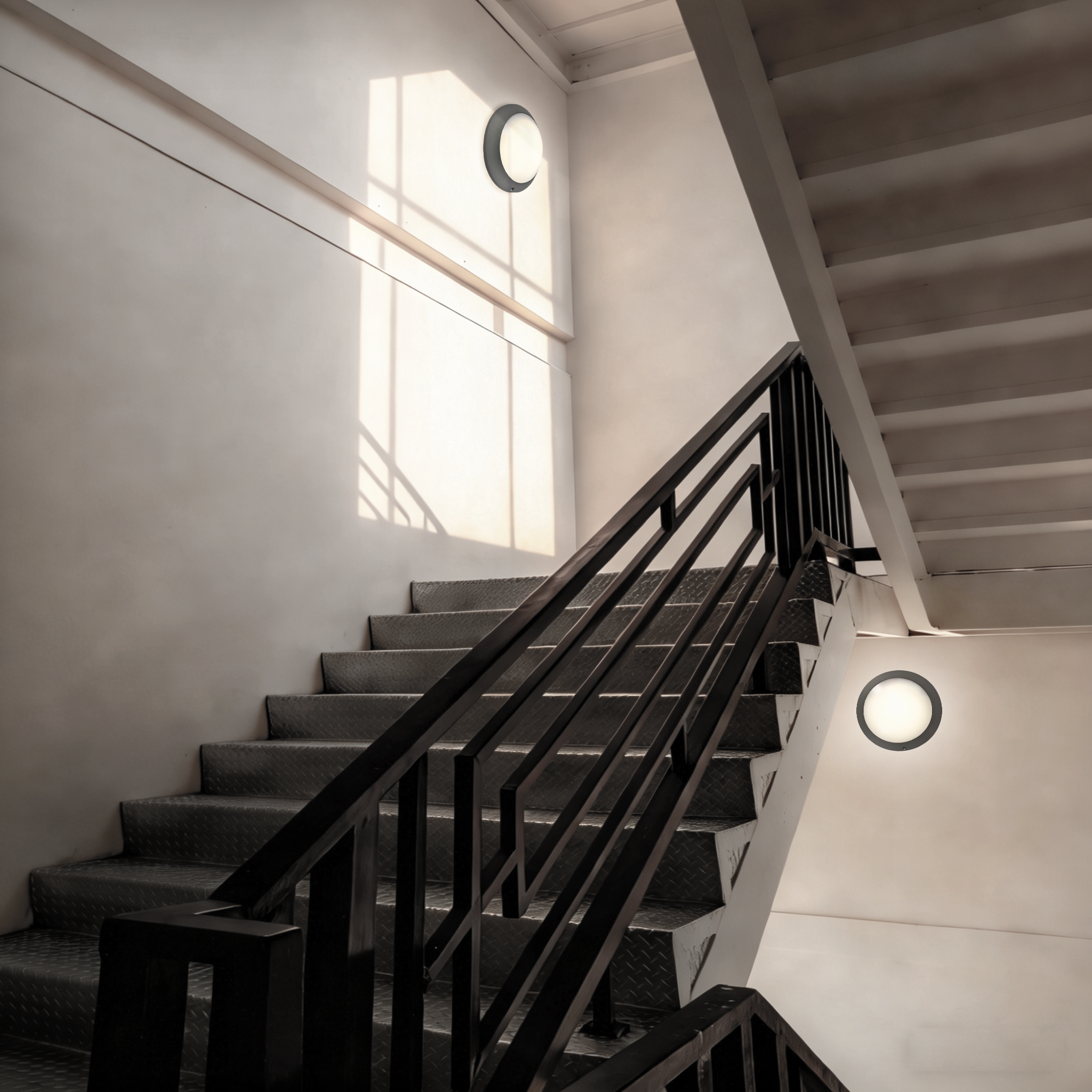 LED ceiling bulkhead lights installed in modern building stairwell providing safe and reliable circulation lighting