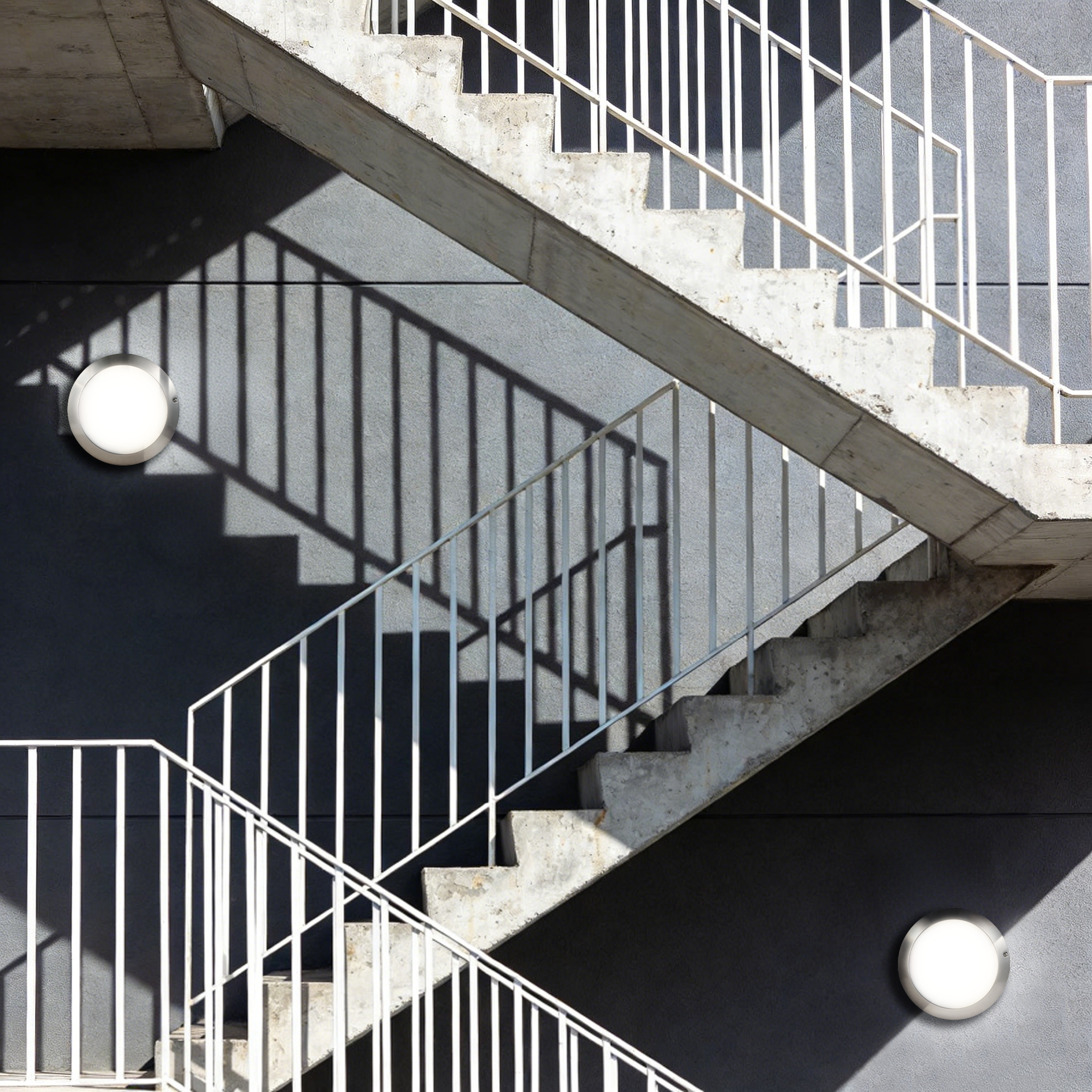 LED wall-mounted bulkhead light installed on outdoor staircase providing safe circulation lighting