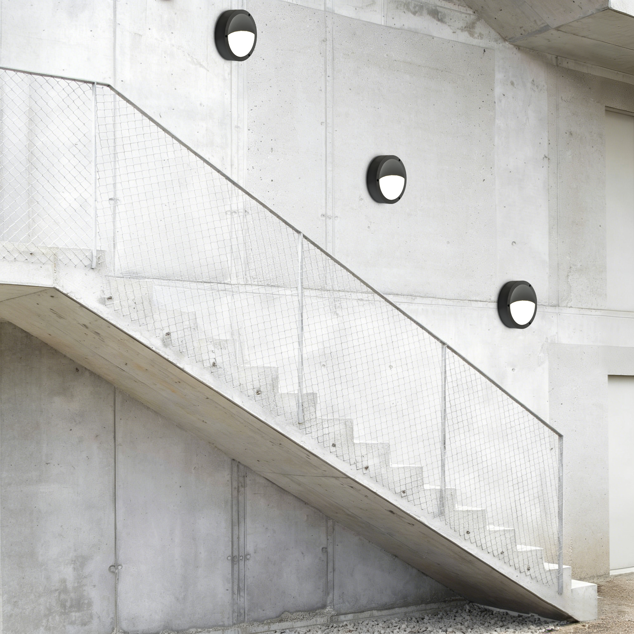 LED wall-mounted bulkhead lights installed on exterior concrete staircase providing safe outdoor circulation lighting