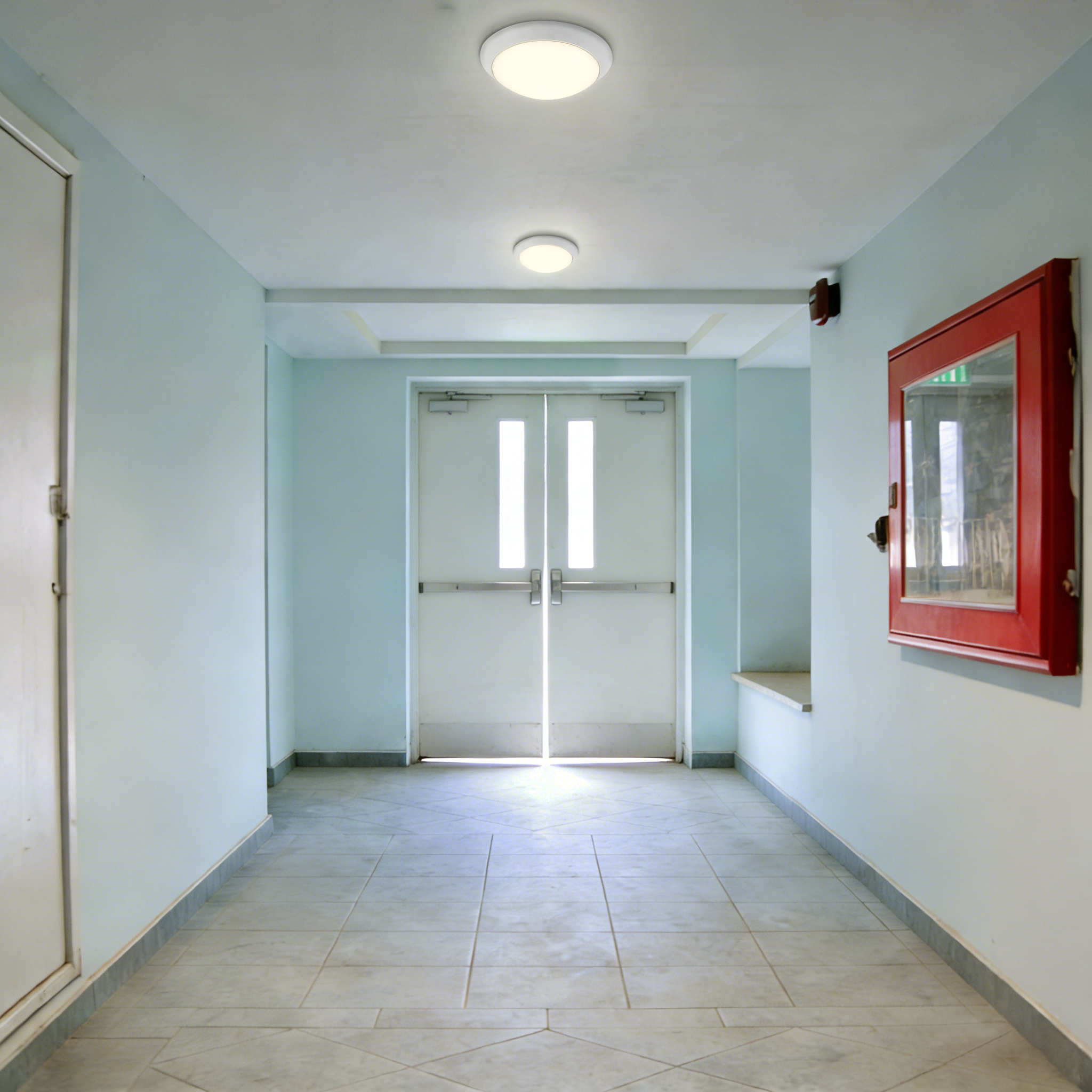 LED ceiling lights installed in emergency exit corridor providing reliable lighting for safe building evacuation