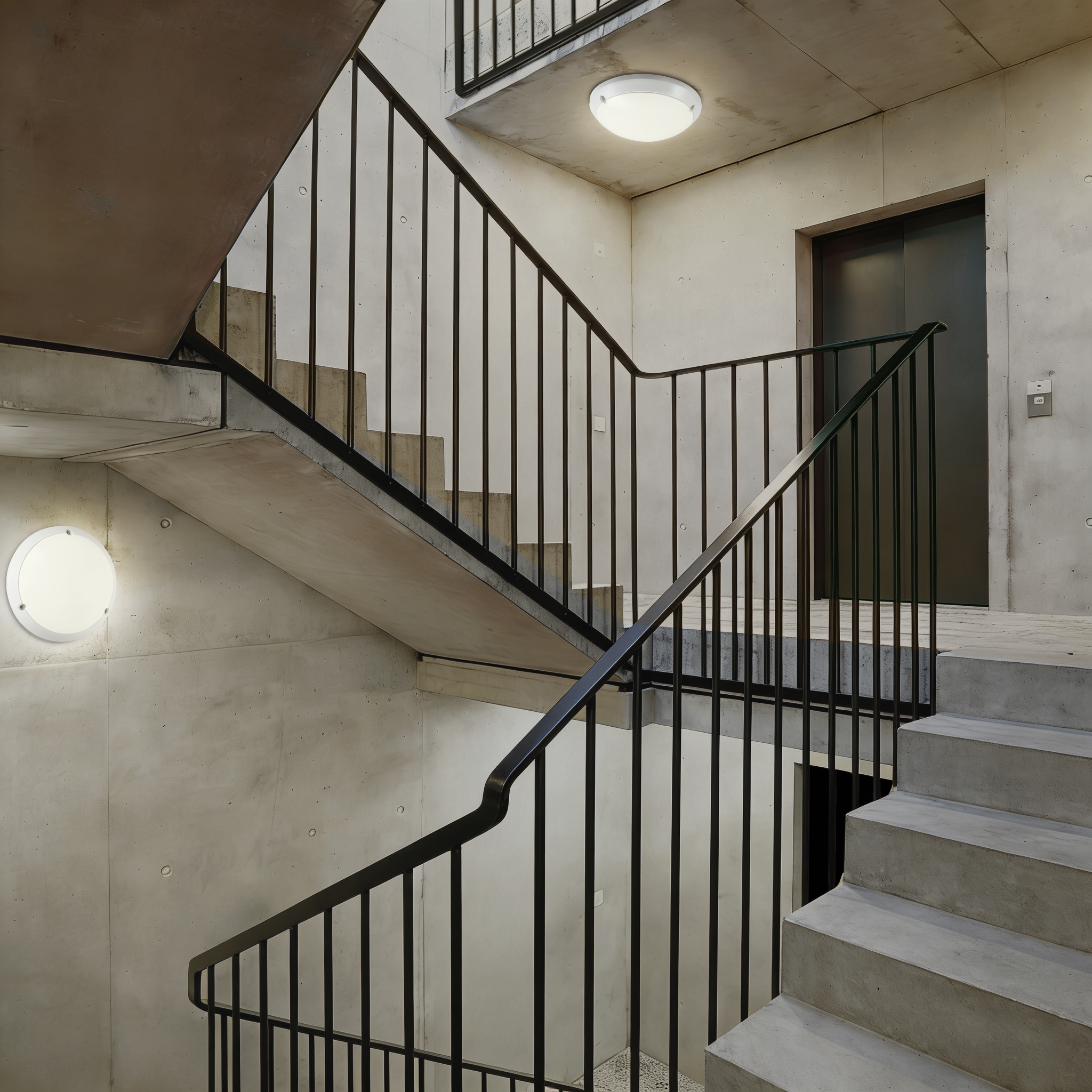 LED ceiling and wall-mounted bulkhead lights installed in residential building stairwell providing safe circulation lighting