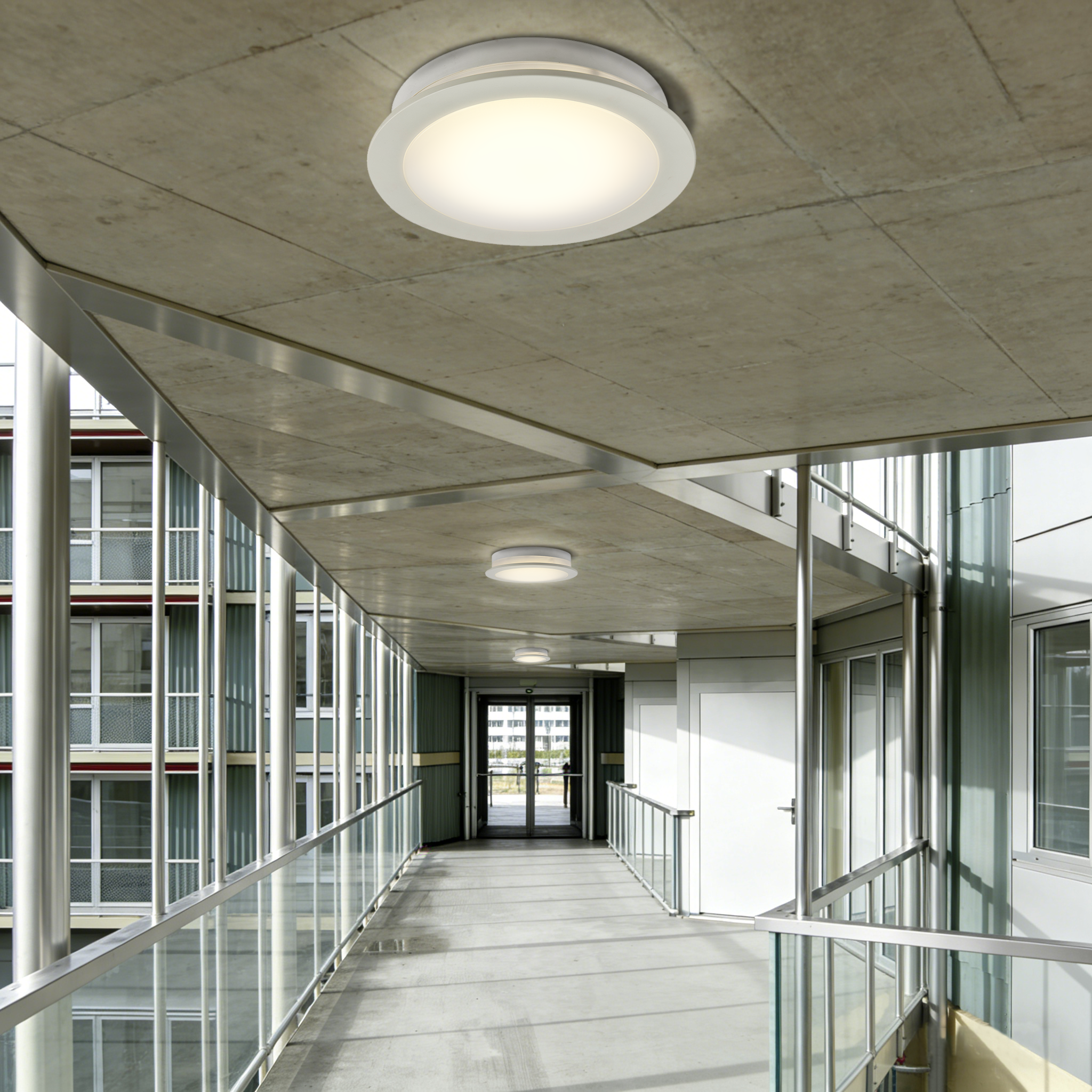 IP65 LED ceiling bulkhead lights used in covered exterior corridor to ensure durable and reliable outdoor building lighting