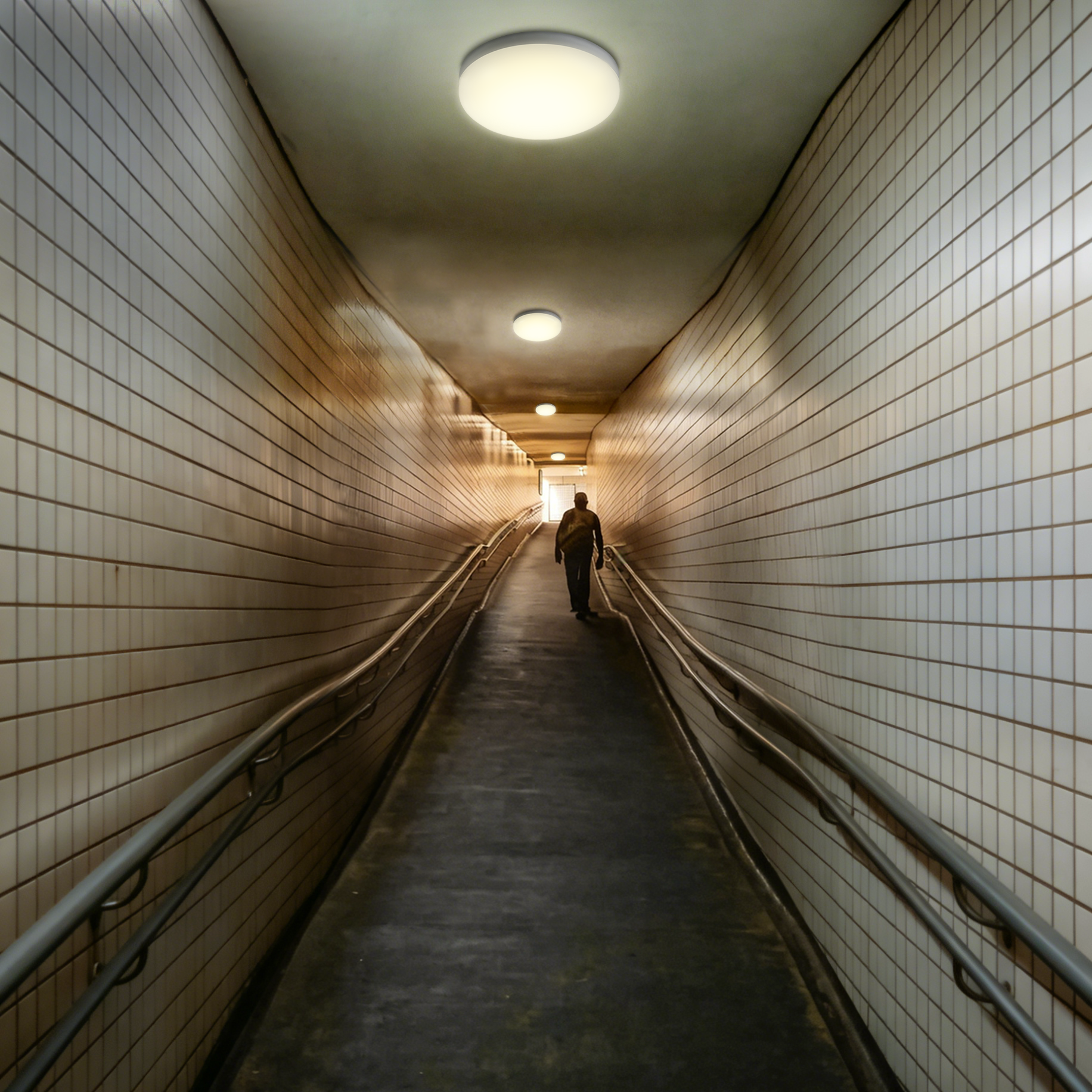 LED ceiling lights installed in underground pedestrian tunnel providing safe corridor and ramp lighting