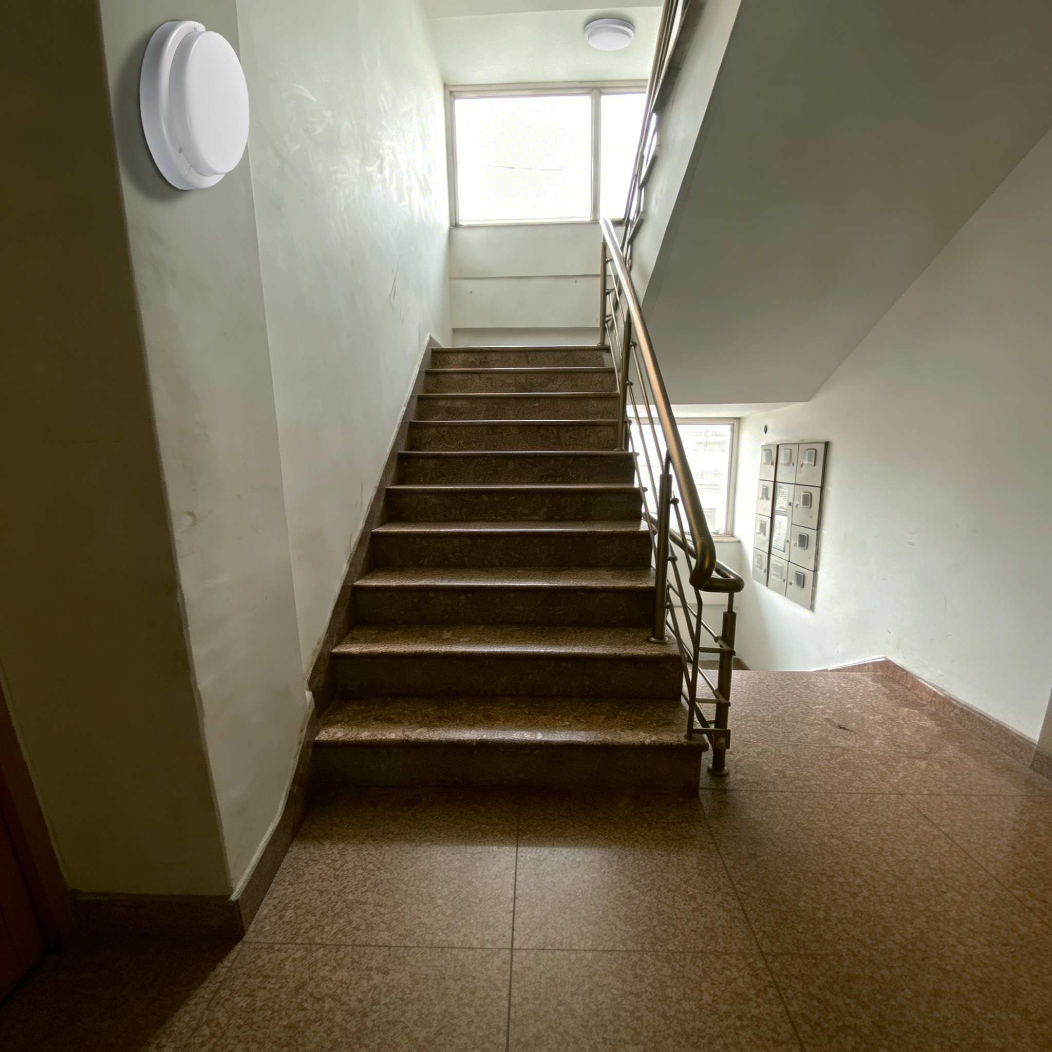 LED ceiling bulkhead light installed in residential building stairwell providing safe and reliable lighting for common areas