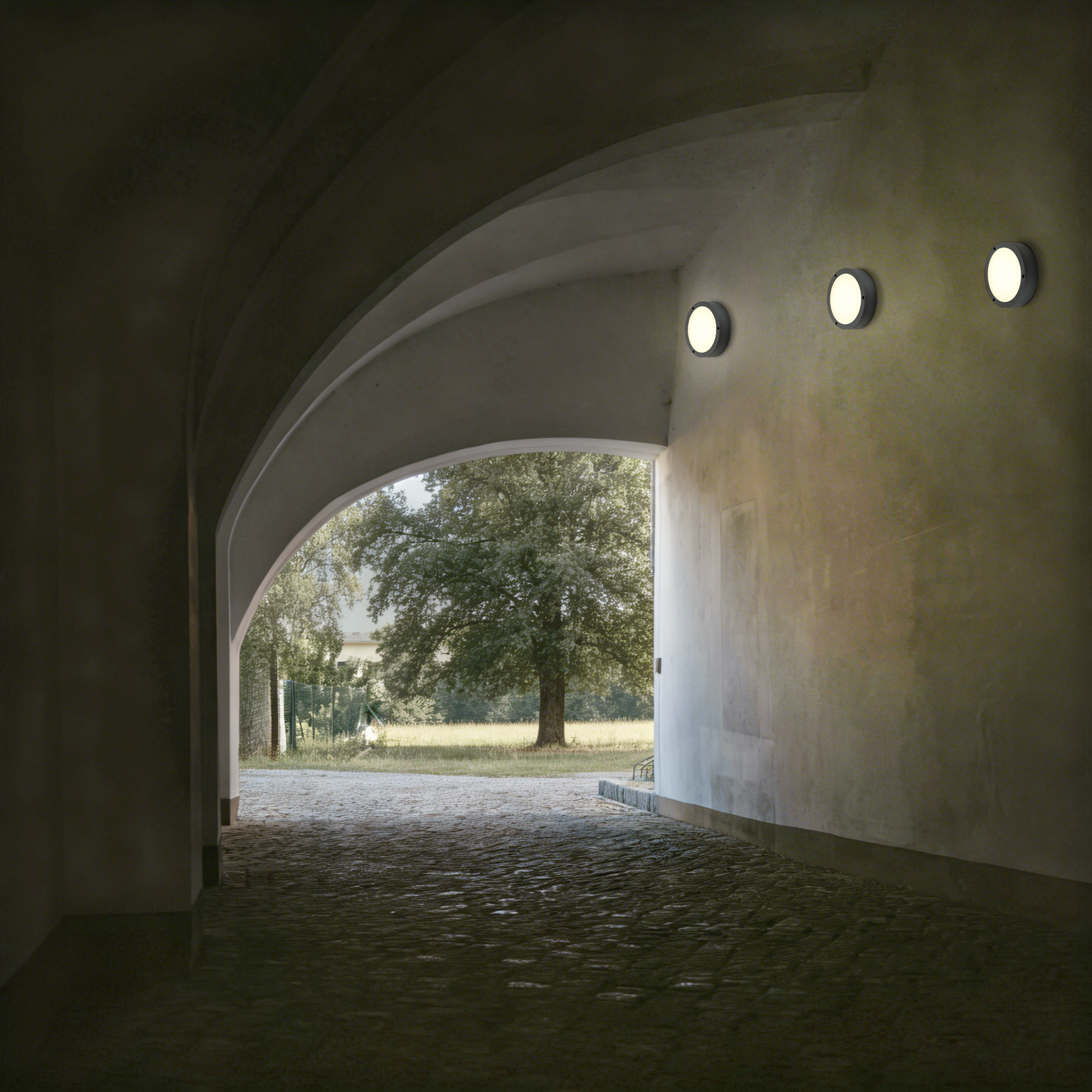 IP65 LED wall light used in covered building passage ensuring reliable lighting in semi-outdoor environments