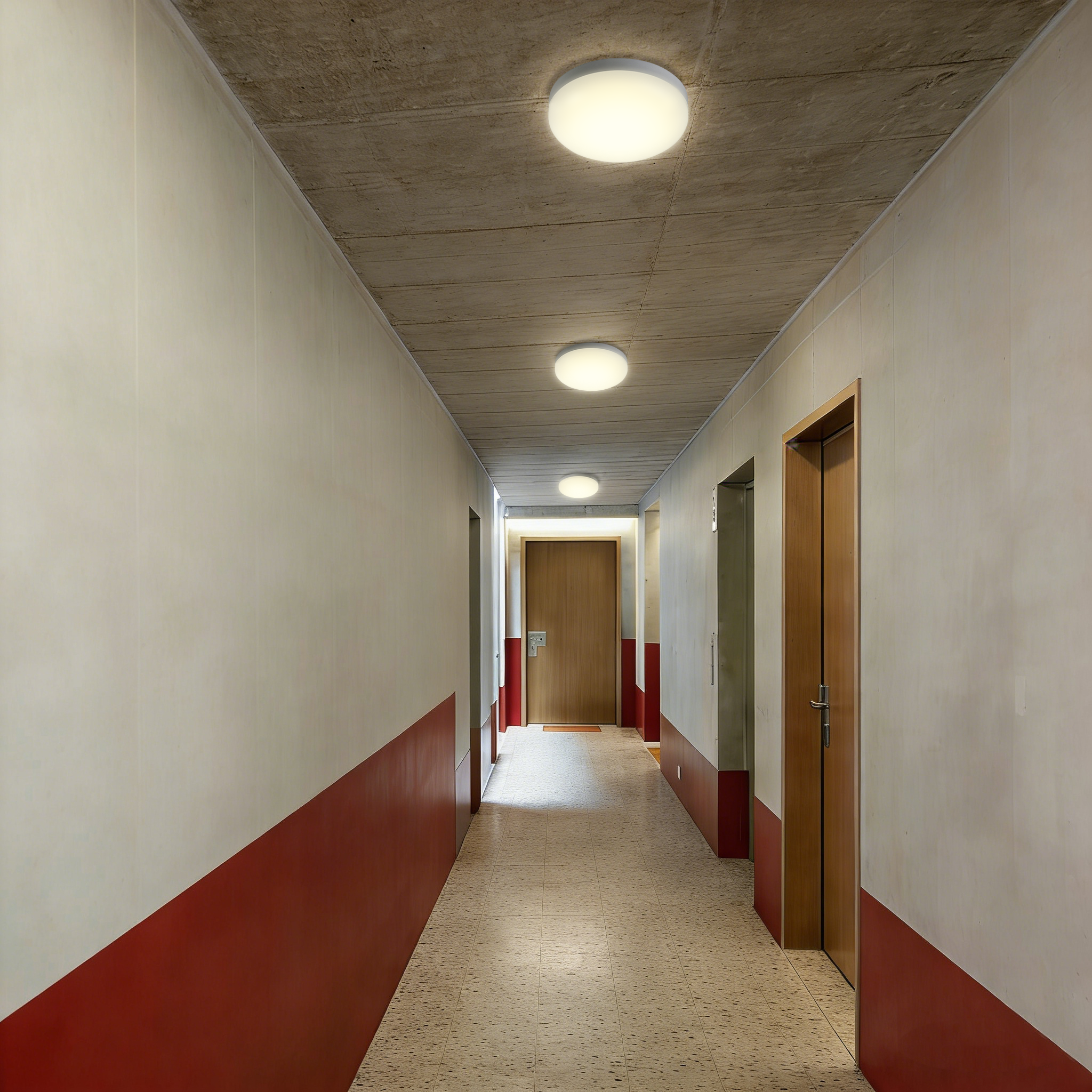 LED ceiling lights installed in apartment building corridor providing reliable indoor hallway lighting