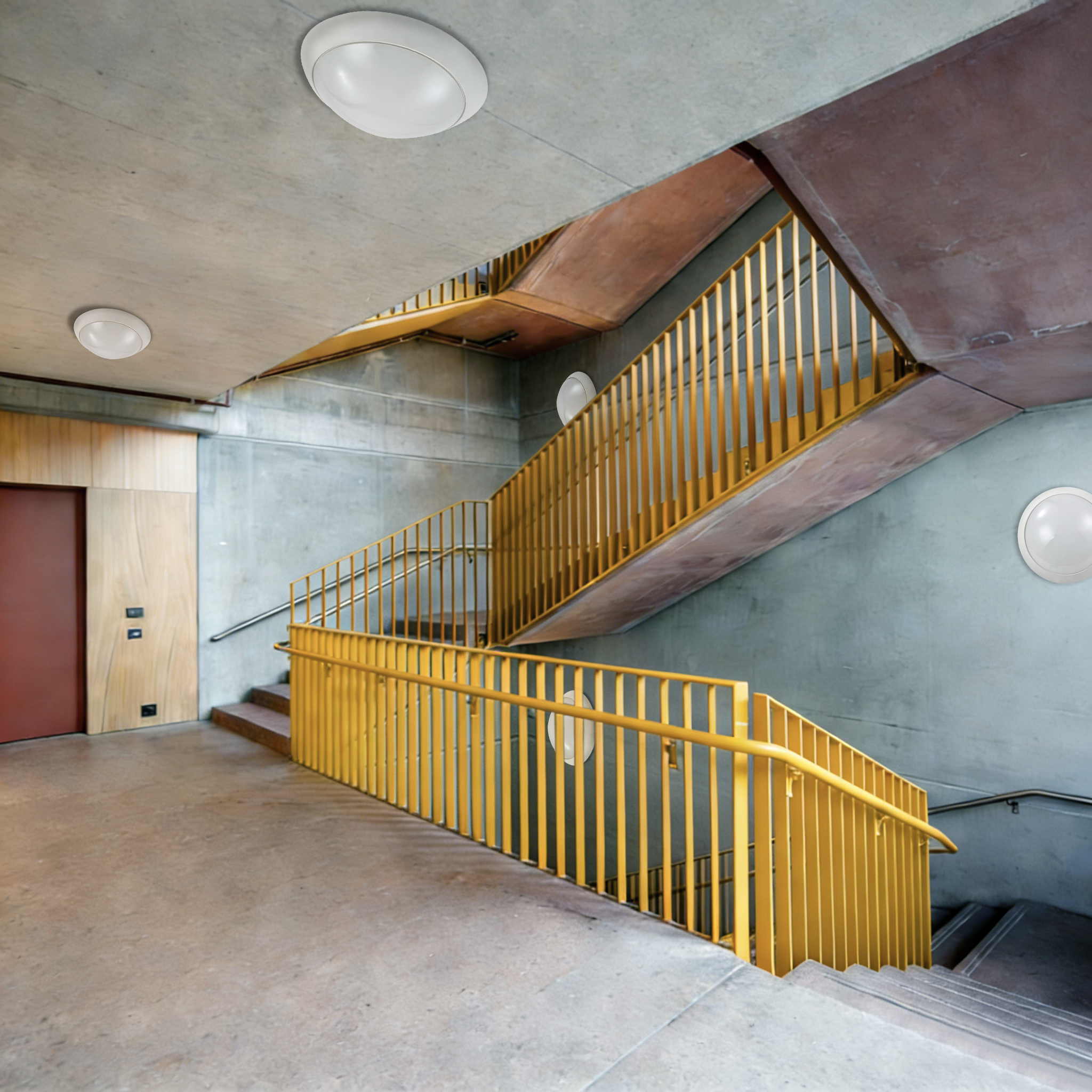 LED ceiling and wall-mounted lights installed in commercial building stairwell providing reliable lighting for public circulation areas