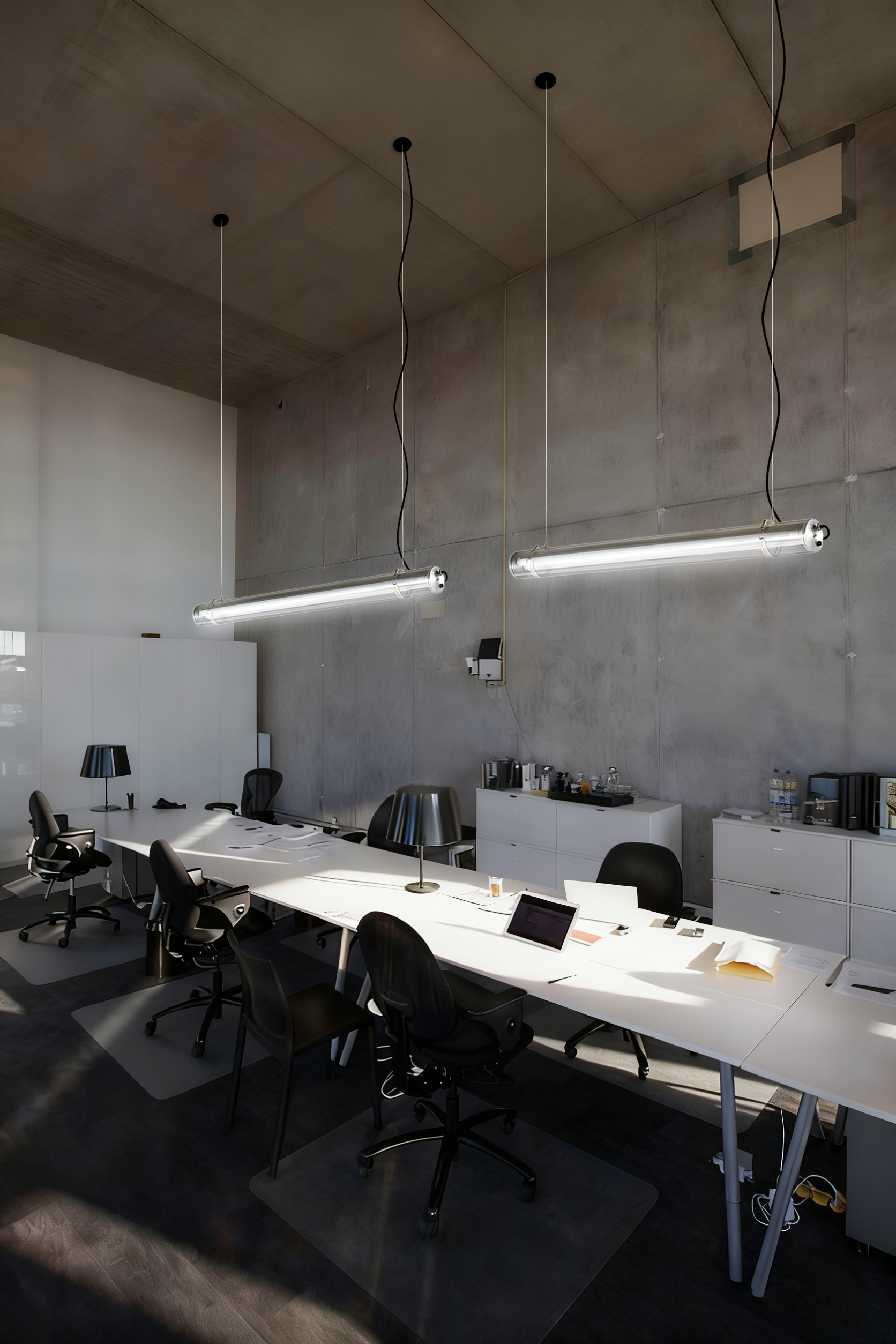 Office workstation lighting solution featuring suspended transparent tubular LED luminaires for task lighting, screen-based work and visual comfort.
