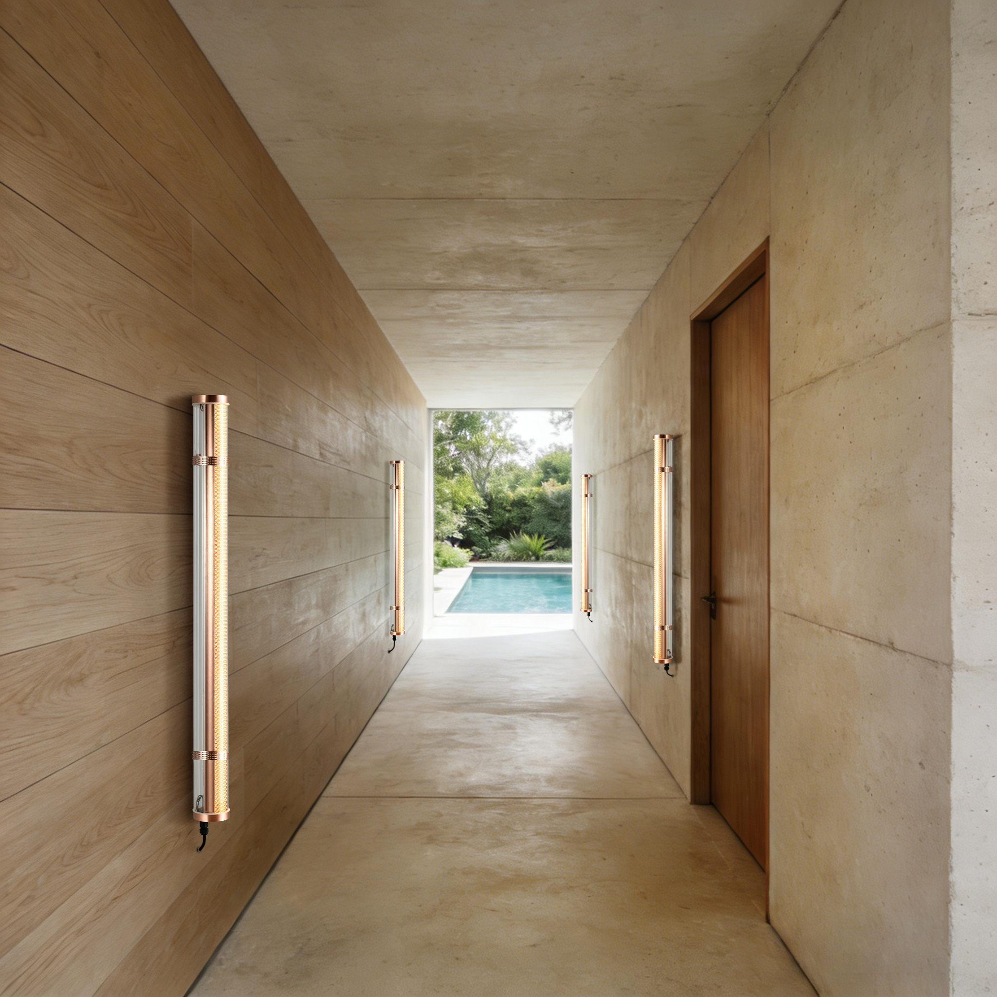 Semi-open outdoor passage with wall-mounted tubular lights guiding movement toward a courtyard.