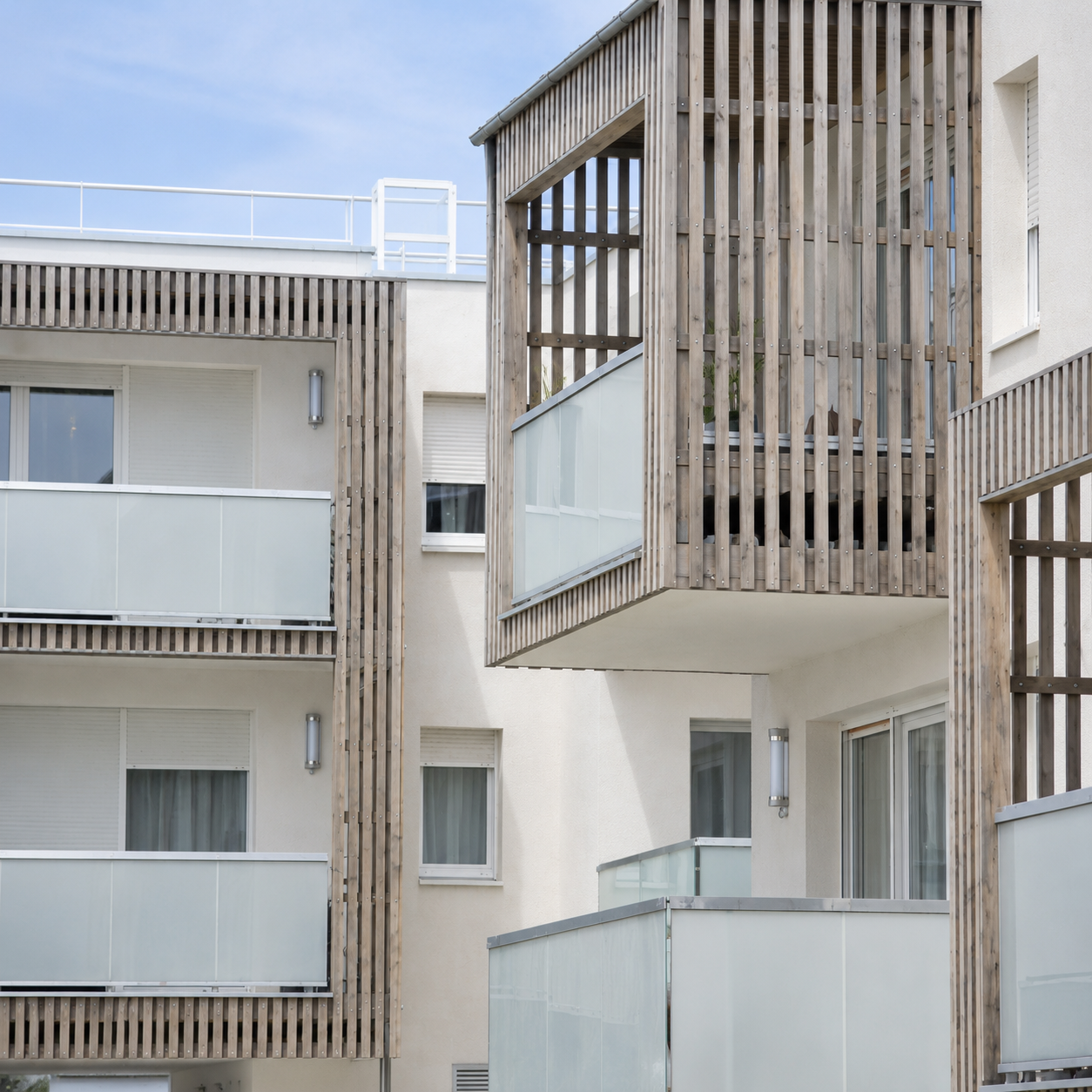 Residential balcony lighting solution with transparent tubular LED wall fixtures for apartment façades and semi-outdoor areas