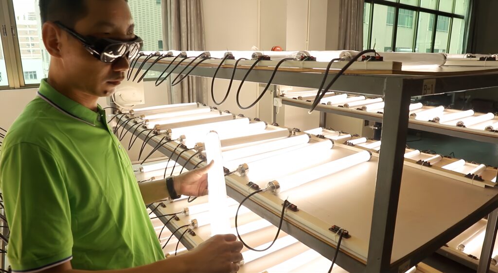 Lighting engineers inspecting LED tri-proof light quality control documents
